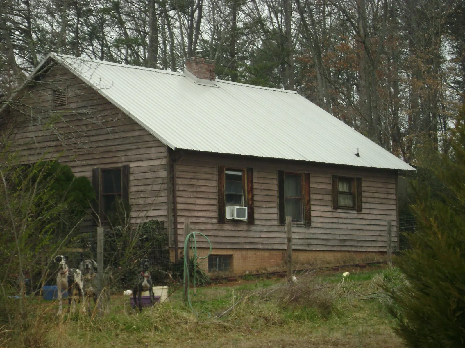 White metal roof on an old wood sided farmhouse, from a Metal Roof Installation job in Canterbury